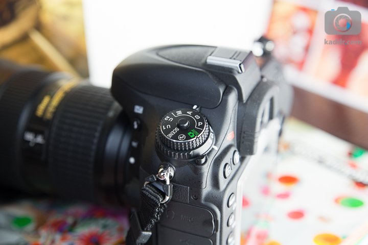 Обзор полнокадровой зеркальной камеры Nikon D610 - колесо переключения режимов с кнопками блокировки